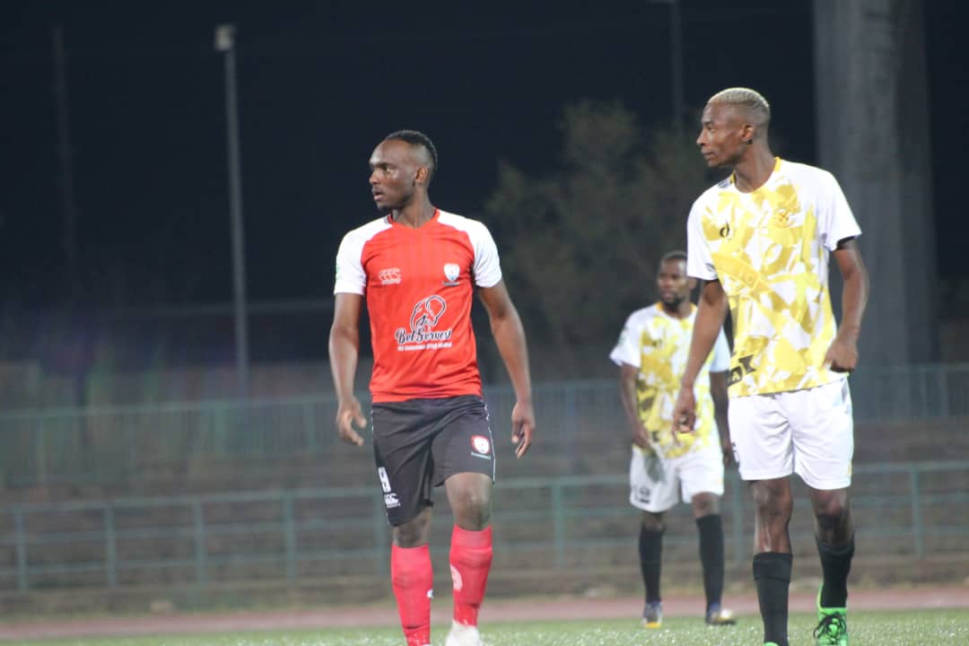 Patrick Kaunda(red) of Jwaneng Galaxy and Thato Seagatleng(yellow) of Notwane looking on.The game ended with a 1 nil win for Galaxy